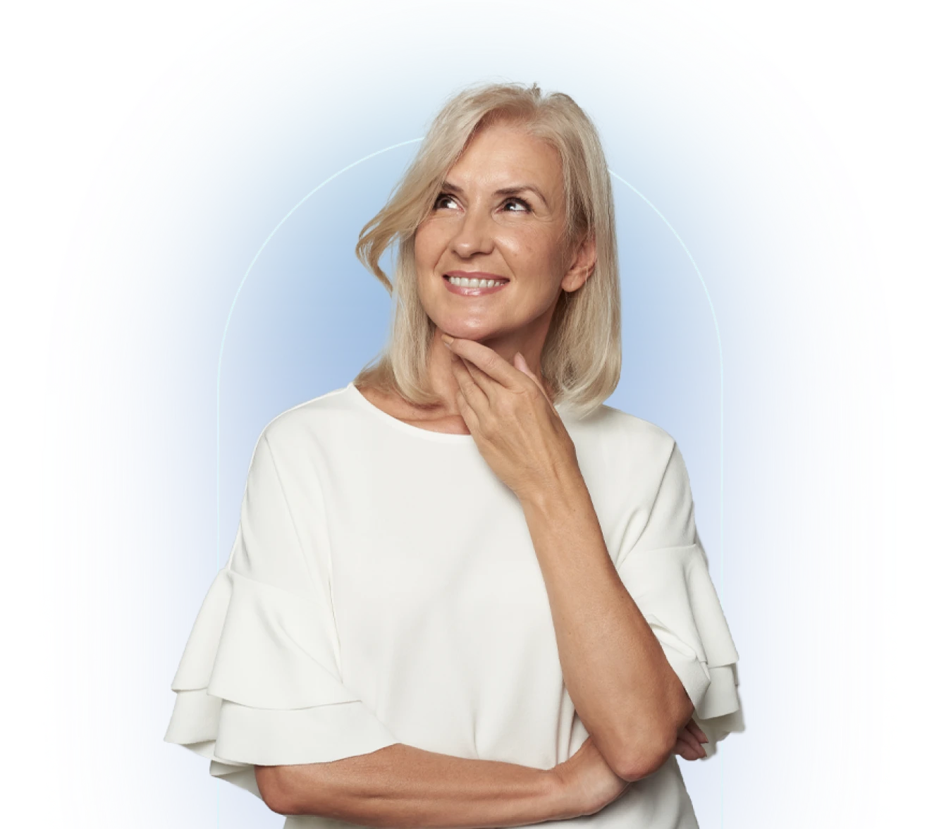 Person in white cardigan with hand near neck indoors